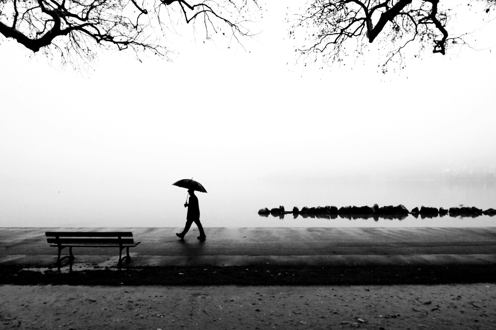 Man walking alone in the rain, reflecting on the meaning of life